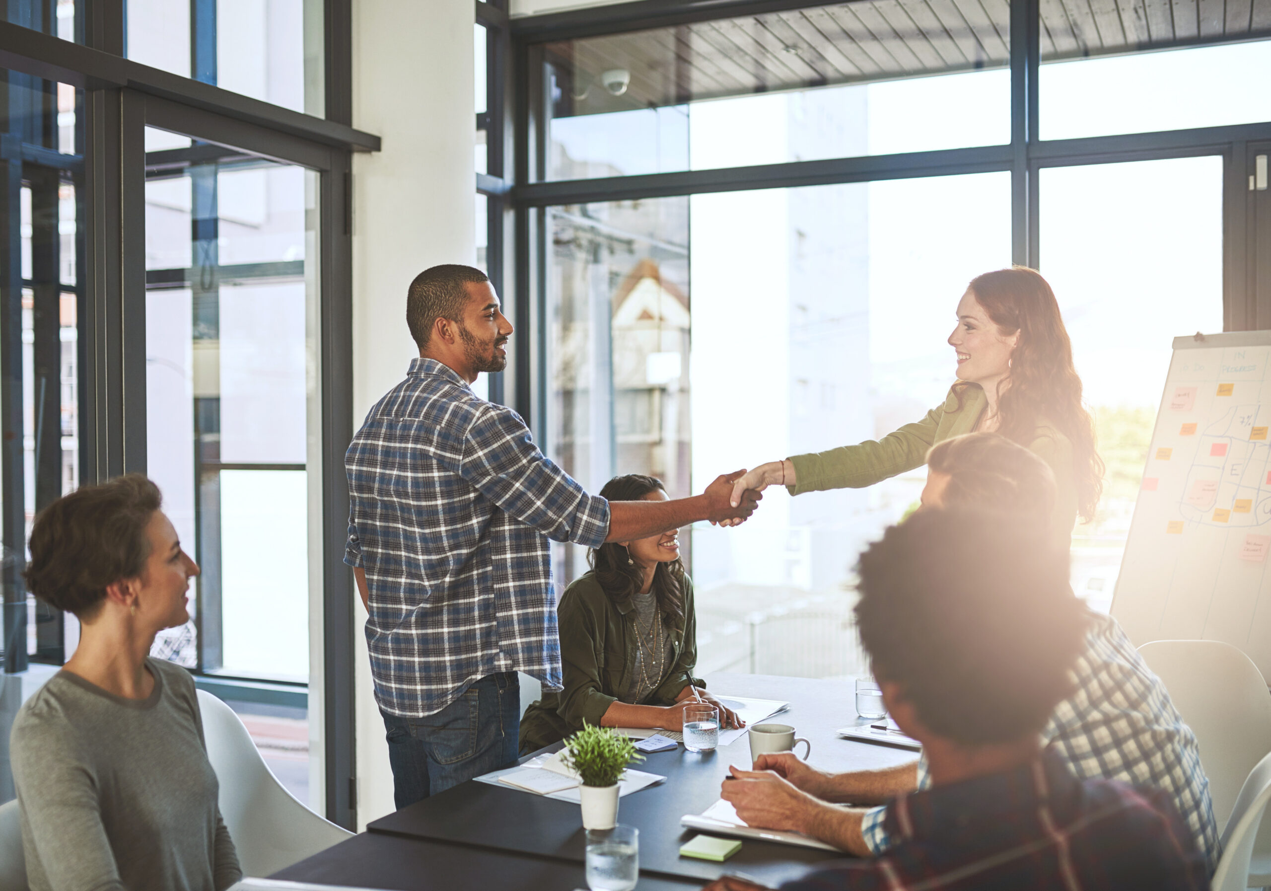 Employees, shaking hands and presentation in office with client, negotiation and acquisition. Business people, meeting and thank you for partnership at sales agency, welcome and onboarding respect.