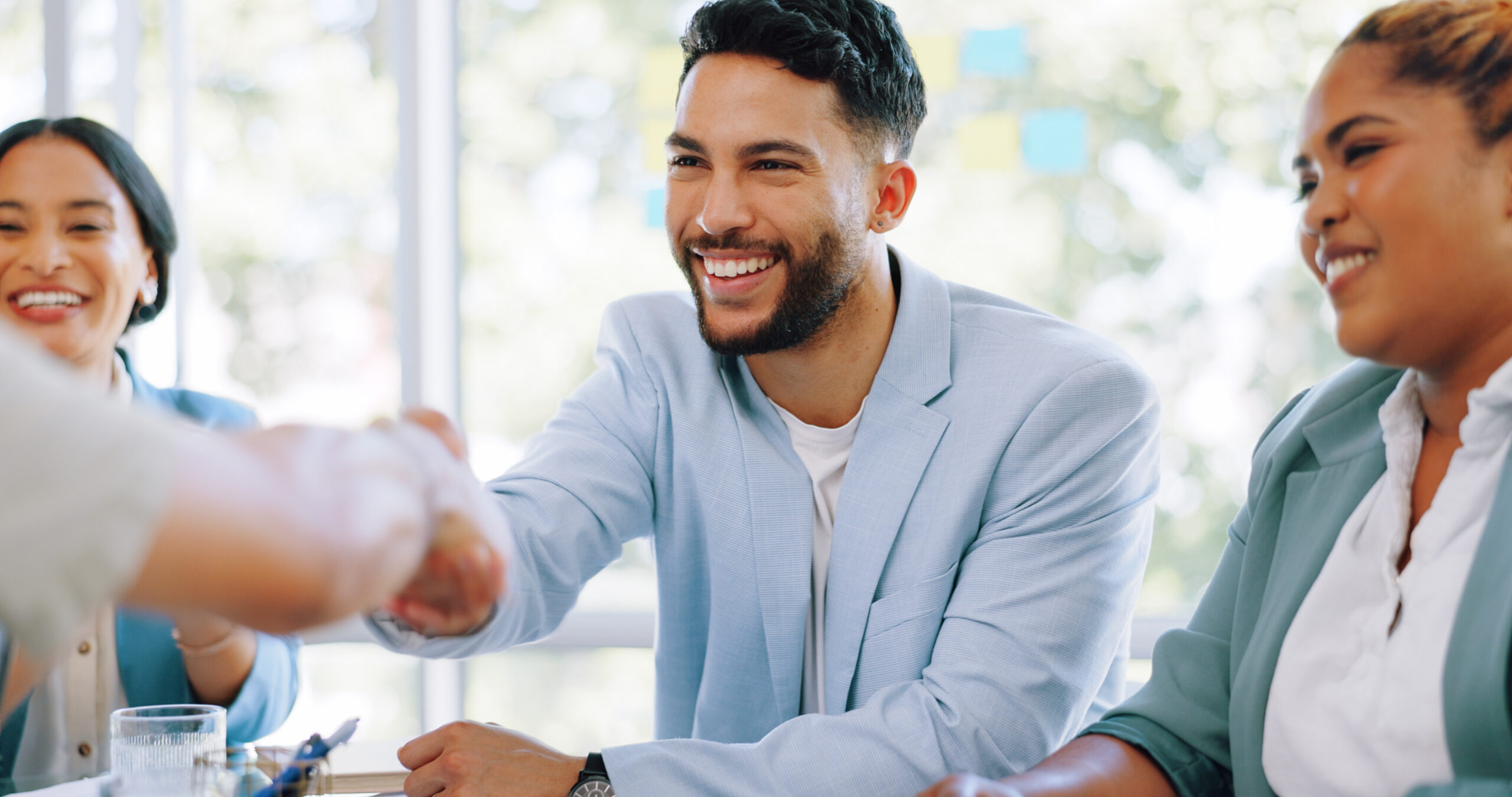 Handshake, partnership and business people in meeting, job interview and success in hiring process. Recruitment, collaboration and man shaking hands for networking, onboarding and welcome in office.