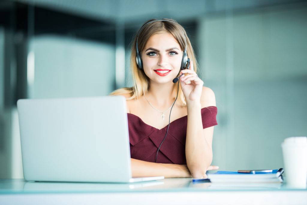 pretty woman support center operator with headset office scaled