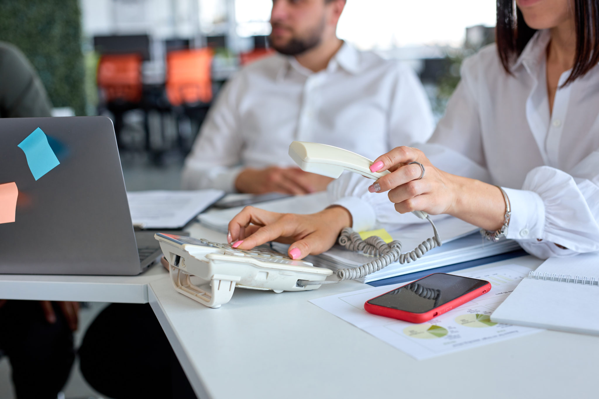 side view cropped photo business lady operator wearing formal wear using landline phone dialing voip phone modern bright office copy space close up photo hands business coworking scaled